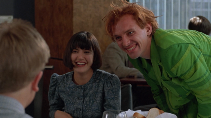 Phoebe Cates and a man in a green shirt