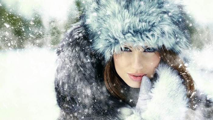 Woman in fur hat and coat in snow