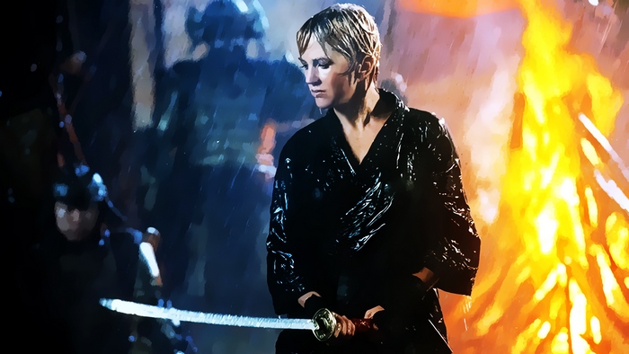 Renee O'Connor with a sword in the rain