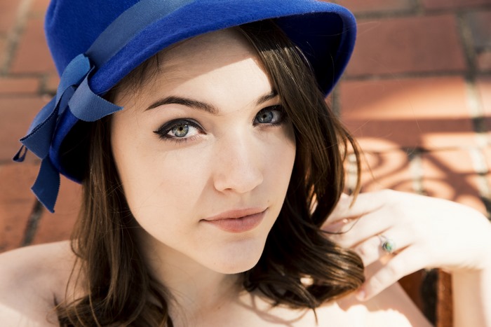 Violett Beane wearing a blue hat