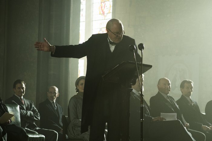Winston Churchill speaking at a podium