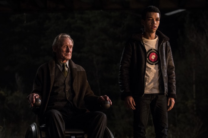 Bill Nighy in a wheelchair with a young man