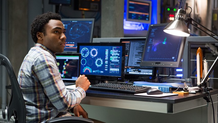 Donald Glover in a control room with multiple monitors