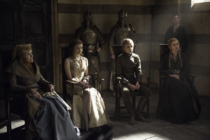 Diana Rigg and other characters in a room