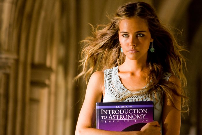 Isabel Lucas holding Introduction to Astronomy book
