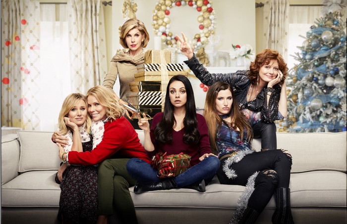 A Bad Moms Christmas cast posing with gifts