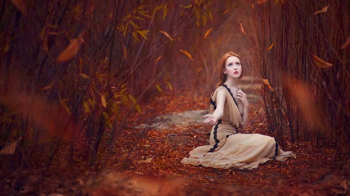 Woman in a dress in an autumn forest