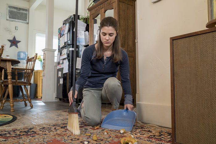 Lucy Griffiths cleaning floor