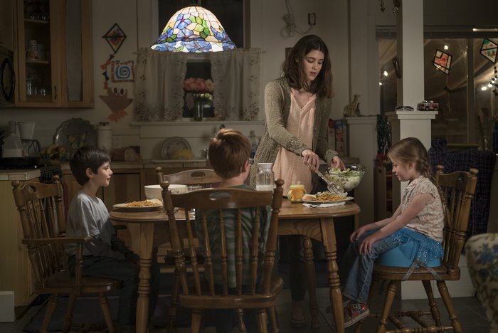 Lucy Griffiths serving salad to children at table