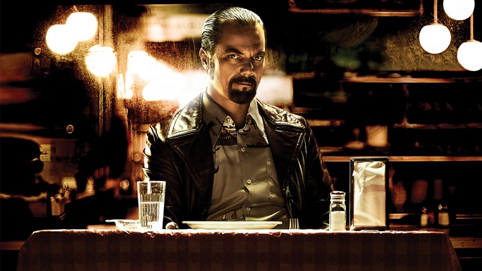 Michael Shannon sitting at a table
