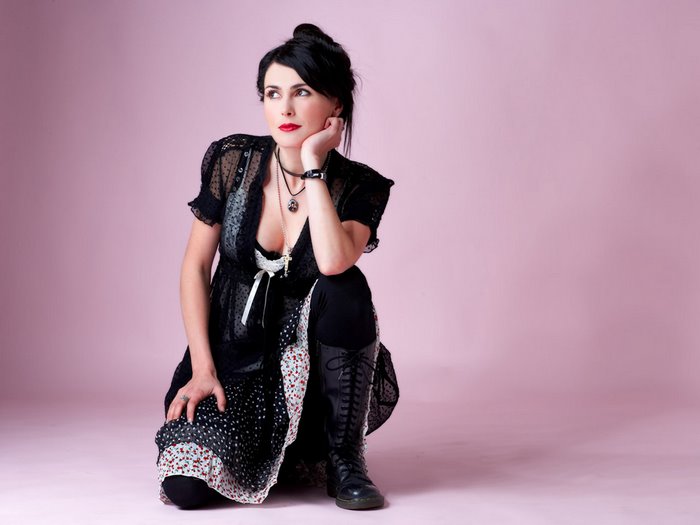 Sharon den Adel in Elegant Black Dress and Boots