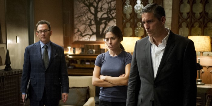 Sarah Shahi in a formal room