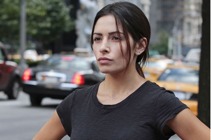Sarah Shahi in a city street