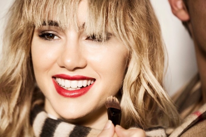 Suki Waterhouse applying makeup