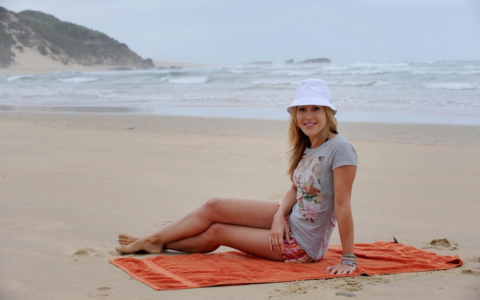 Woman on a beach with ocean in background