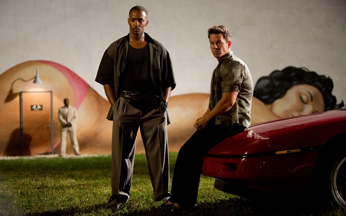 Daniel Lugo and Mark Wahlberg in front of a mural