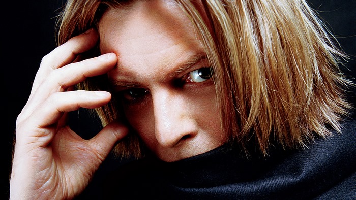 David Bowie with hand on forehead