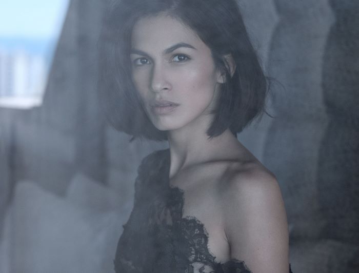 Portrait of Élodie Yung with Intense Gaze Through Glass
