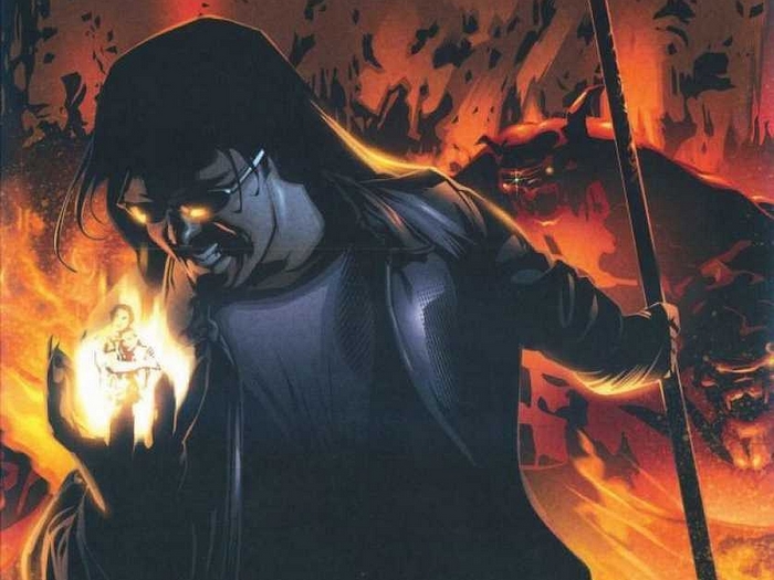 Gene Simmons holding a small figure in flames
