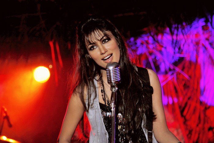 Chitrangada Singh singing into a microphone
