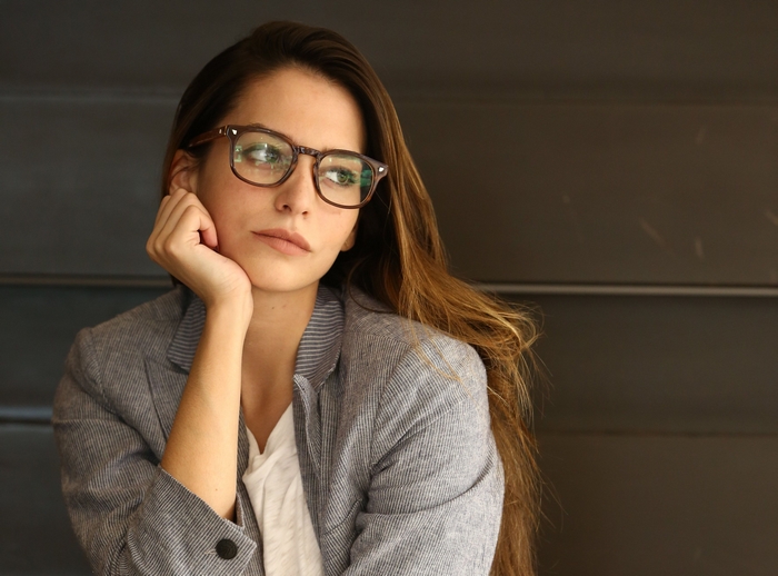 Génesis Rodríguez wearing glasses and a blazer
