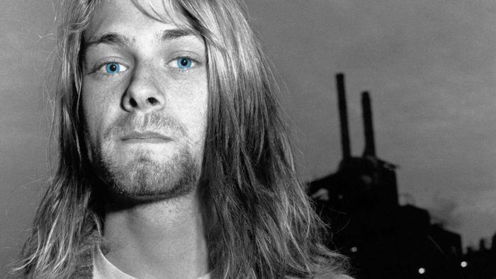 Kurt Cobain in front of industrial background