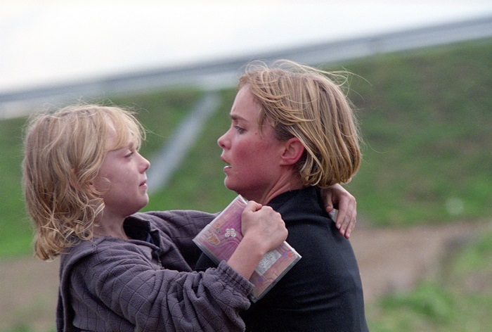 Girl hugging Radha Mitchell