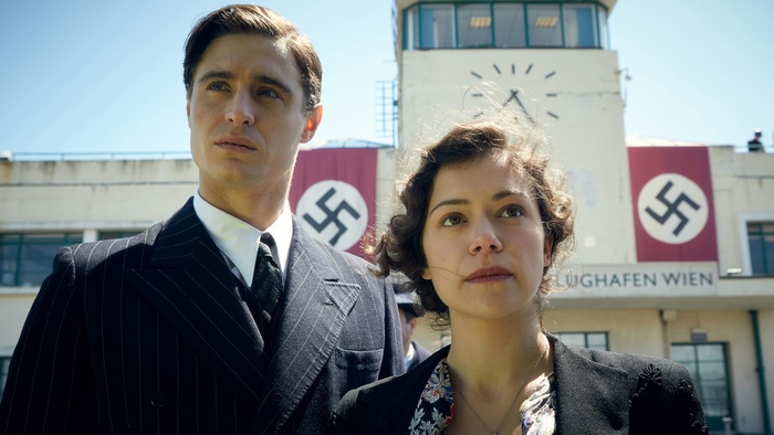 Tatiana Maslany in front of airport with Nazi flags