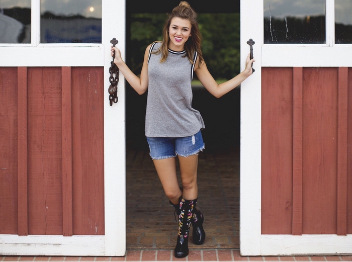 Sadie Robertson standing in barn doorway