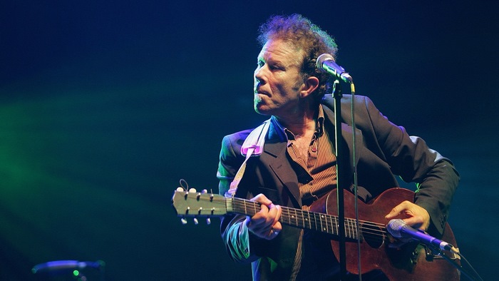 Tom Waits performing live with guitar