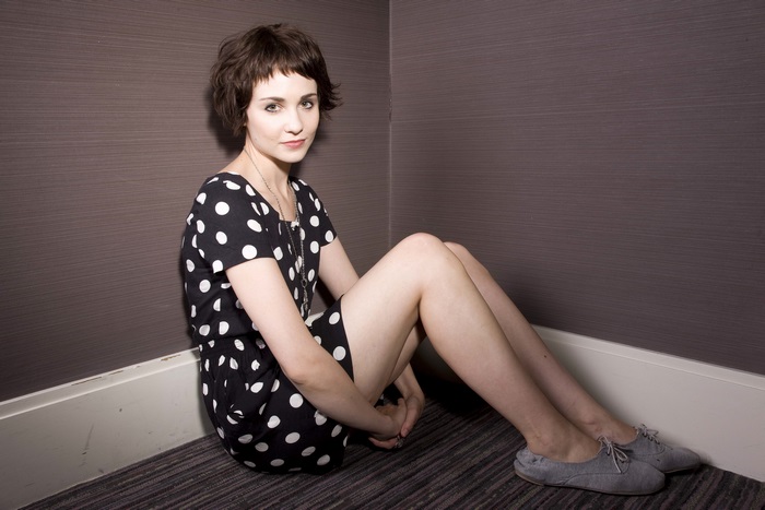 Tuppence Middleton sitting in a corner