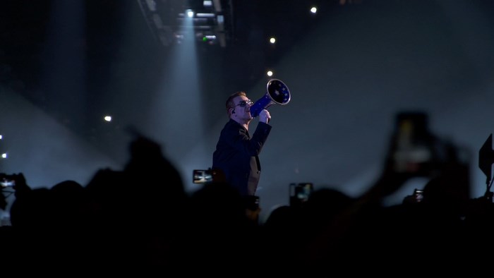 Bono from U2 performing with a megaphone