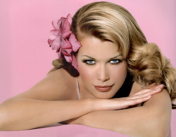 Claudia Schiffer with a pink flower in her hair