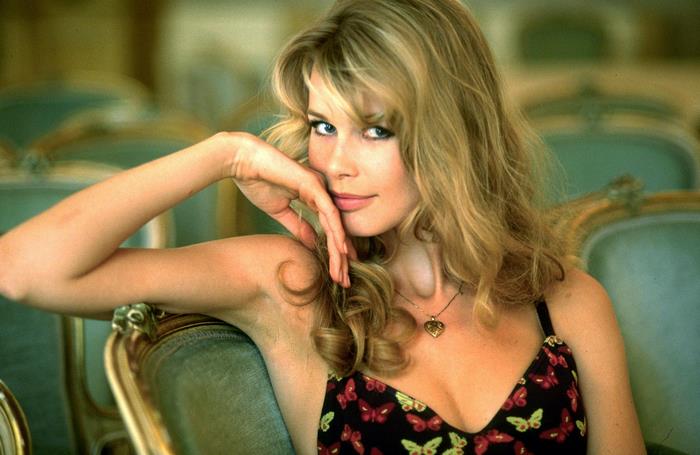 Claudia Schiffer sitting on a chair