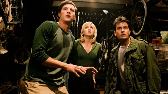 Charlie Sheen and two others in a dark room