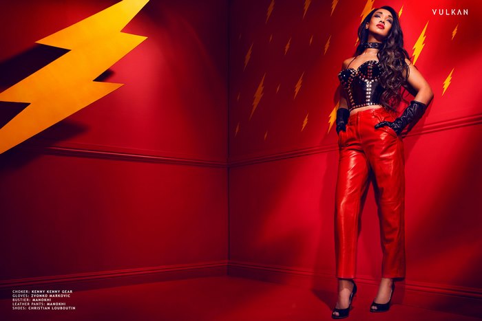 Candice Patton in red leather pants and black bustier