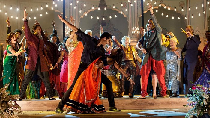 Dev Patel and ensemble in a musical performance