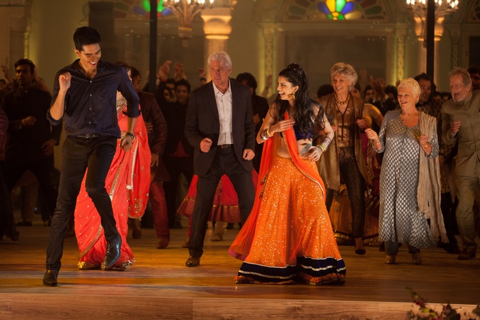 Dev Patel and others dancing at a celebration