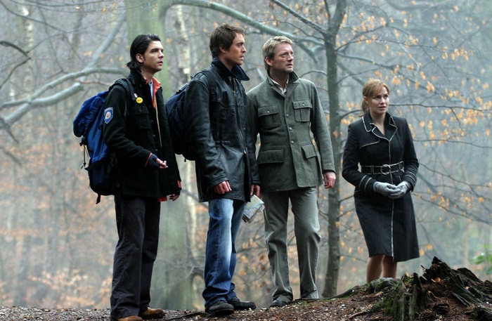 Douglas Henshall and companions in a forest