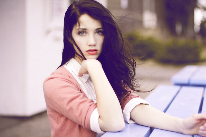 Emily Rudd sitting at a picnic table