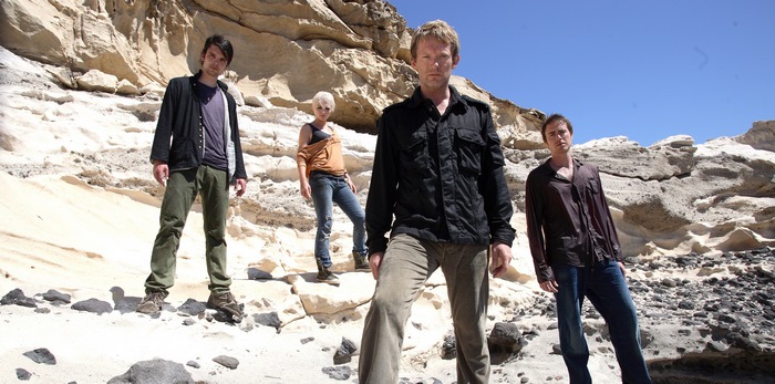 Douglas Henshall and cast on rocky terrain