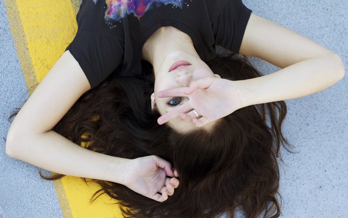 Emily Rudd lying on the ground