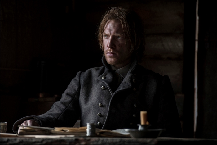 Domhnall Gleeson in a dark room