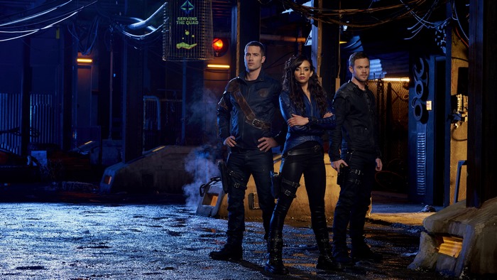 Three people in a dark alley
