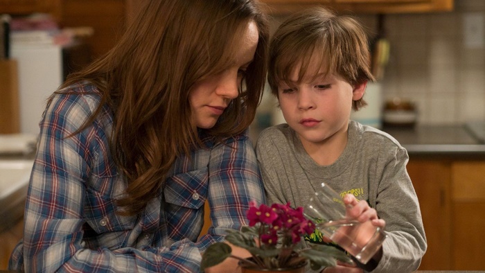 Jacob Tremblay watering a plant