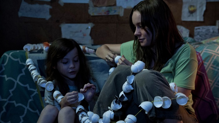 Woman and child making eggshell garland