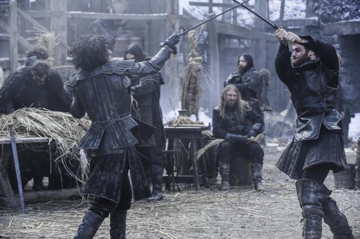Two men sword fighting in a snowy village