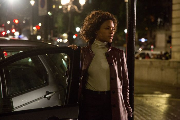 Naomie Harris standing by a car at night