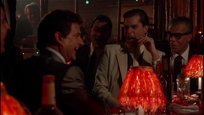 Men laughing at a table with drinks