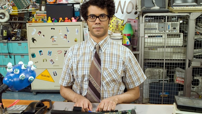 Richard Ayoade in a cluttered office